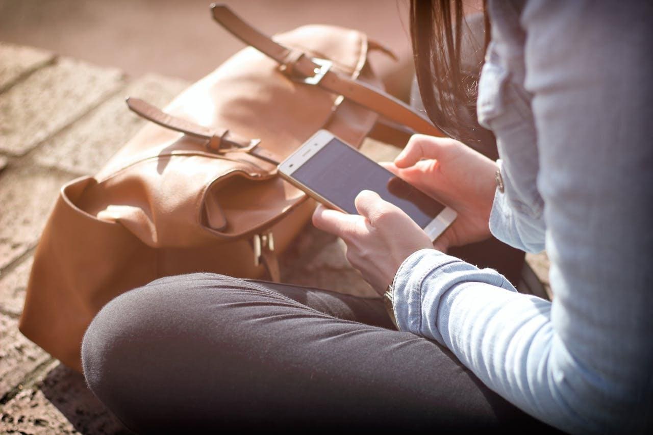 Person using an Android smartphone to interact with a website